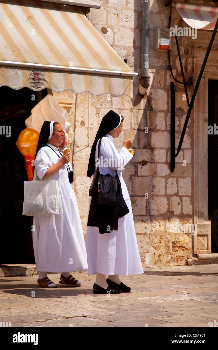 Two nuns enjoying ice cream cones on a hot afternoon in old Dubrovnik, Dalmatia Croatia Stock Photo