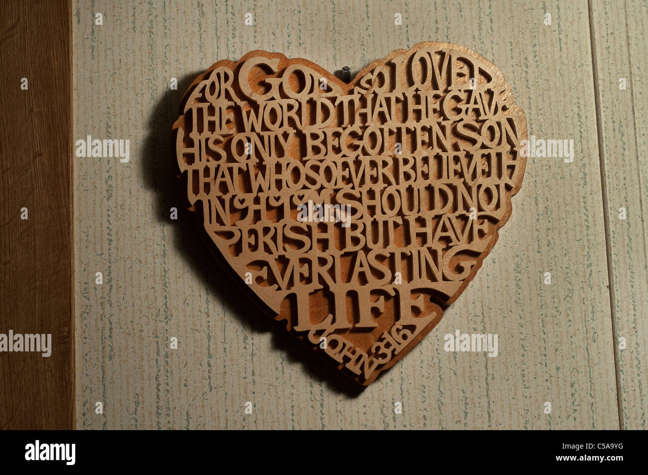 John 3 16 new testament Bible verse carved into a wall plaque Stock Photo