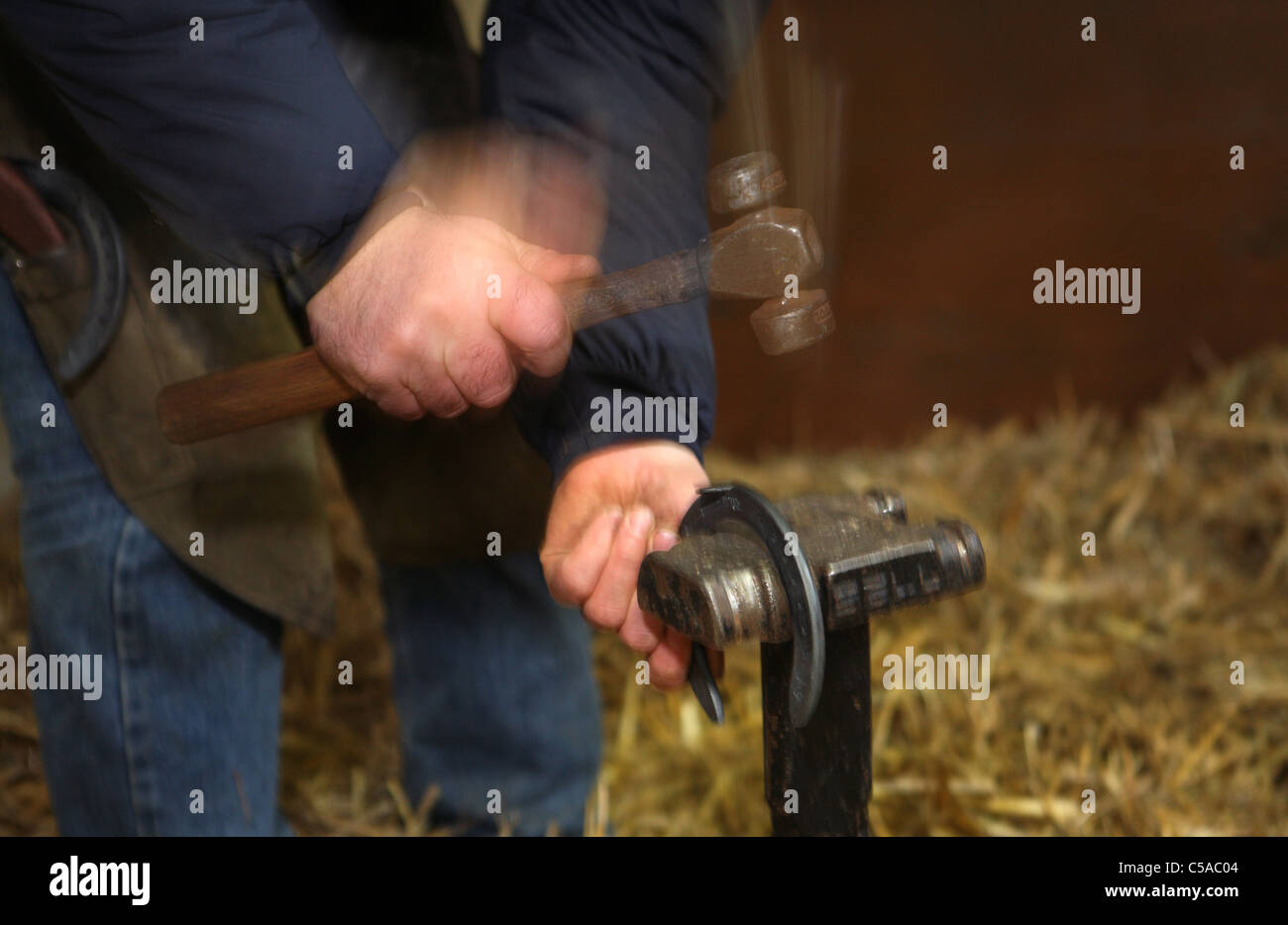 A blacksmith preparing a horseshoe Stock Photo