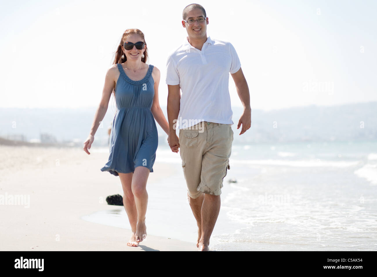happy young couple walk at the beach Stock Photo - Alamy