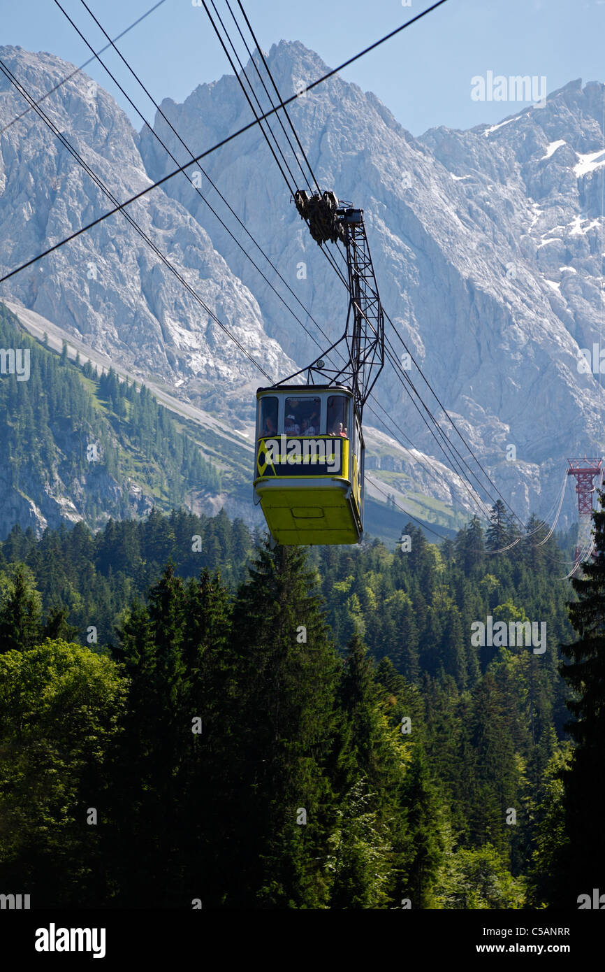 A mountain gondola / cable car on its way from the cable car station at the summit of Zugspitze to Eibsee, Bavaria, Germany Stock Photo