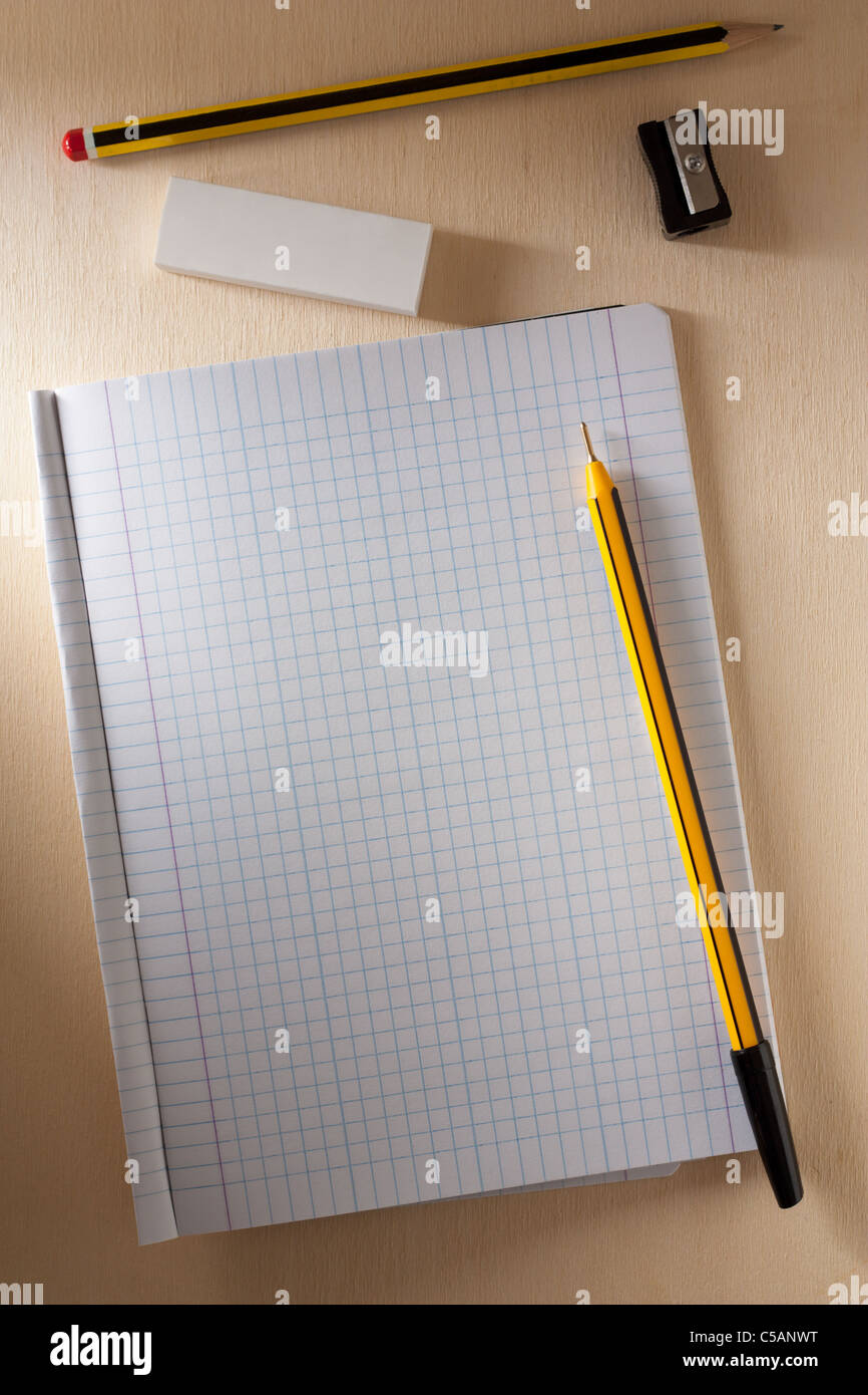 Blank Exercise Book with Pen, Pencil, Rubber and Pencil Sharpener Stock Photo