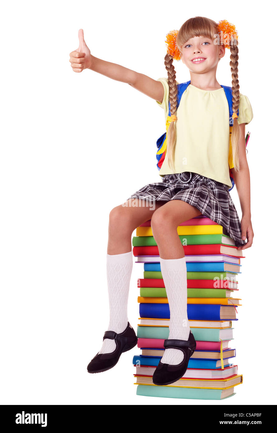 Schoolgirl sitting on pile of books Stock Photo - Alamy
