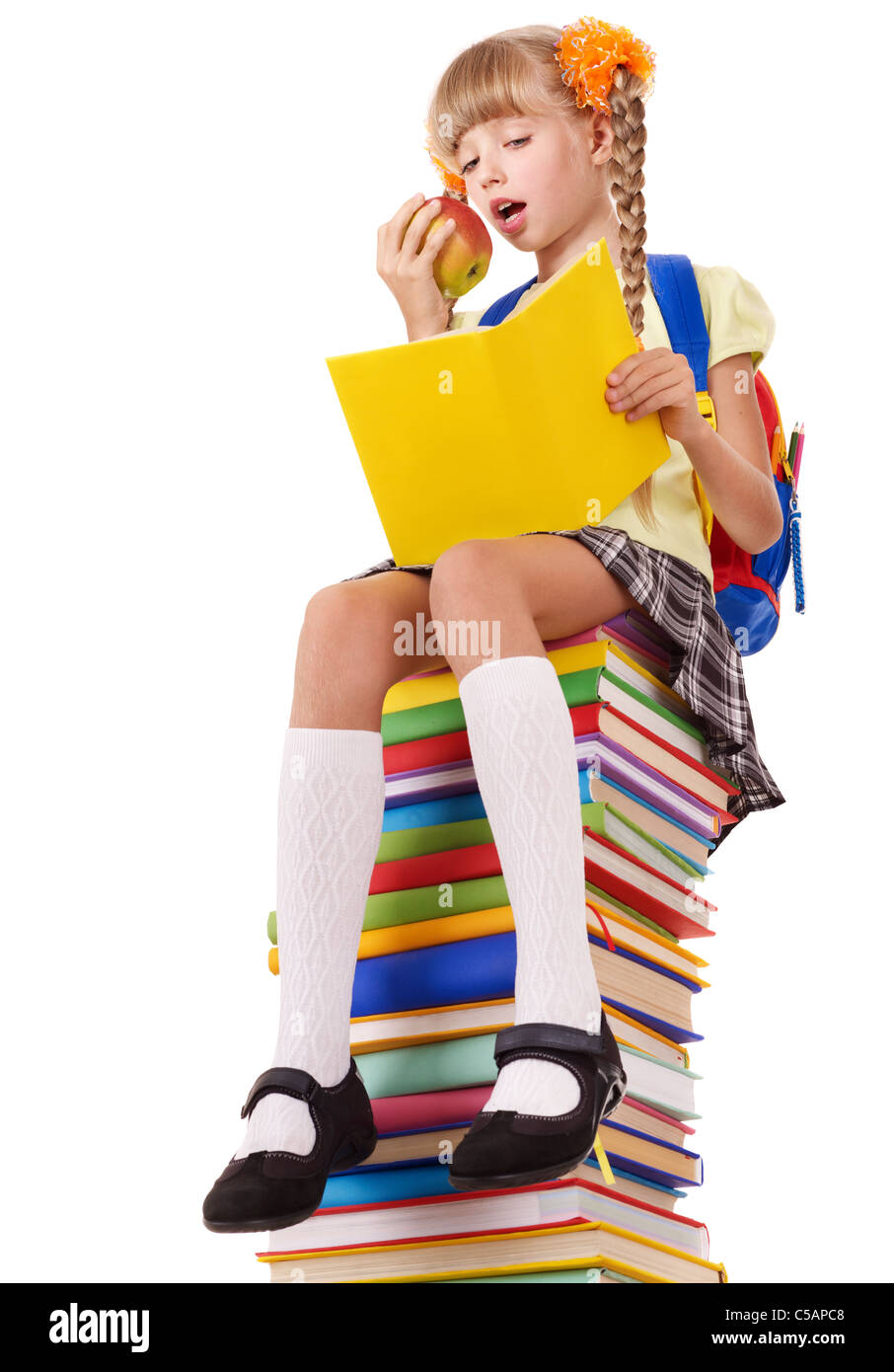 Schoolgirl sitting on pile of books Stock Photo - Alamy