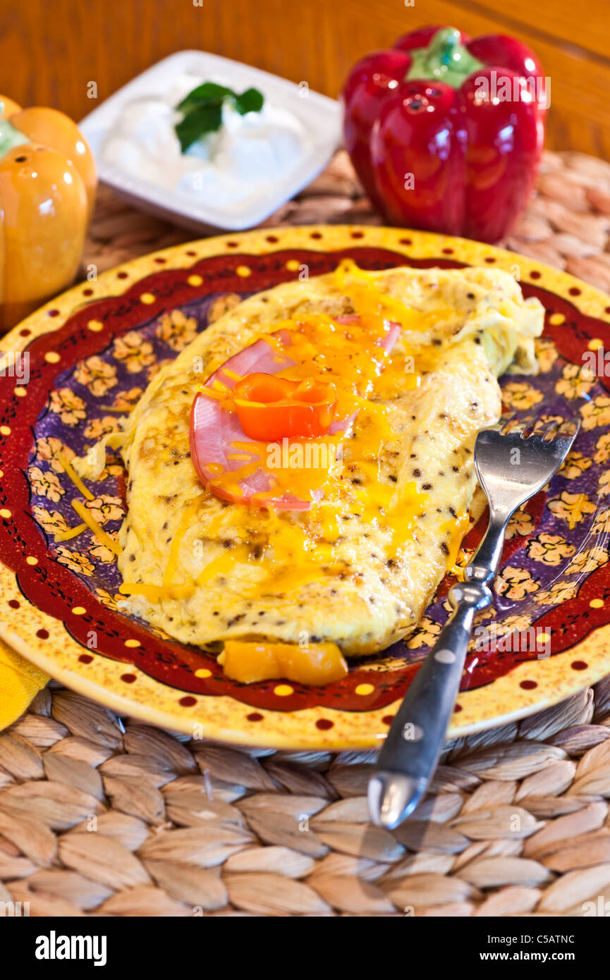 Southwestern Omelet with mushrooms, onions sweet peppers with cheese and Canadian bacon on top. Stock Photo