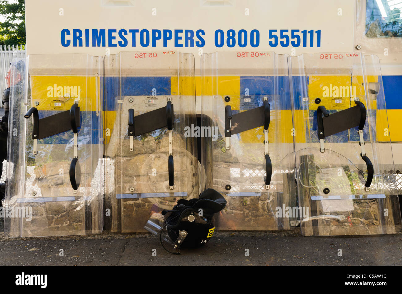 Riot squad shields resting against an armoured Landrover Stock Photo