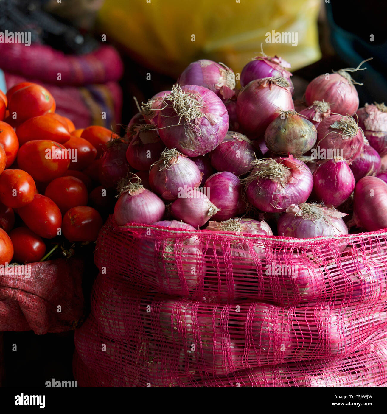 Mesh Bags Full Of Onions Tomatoes And Other Vegetables; Cusco Peru