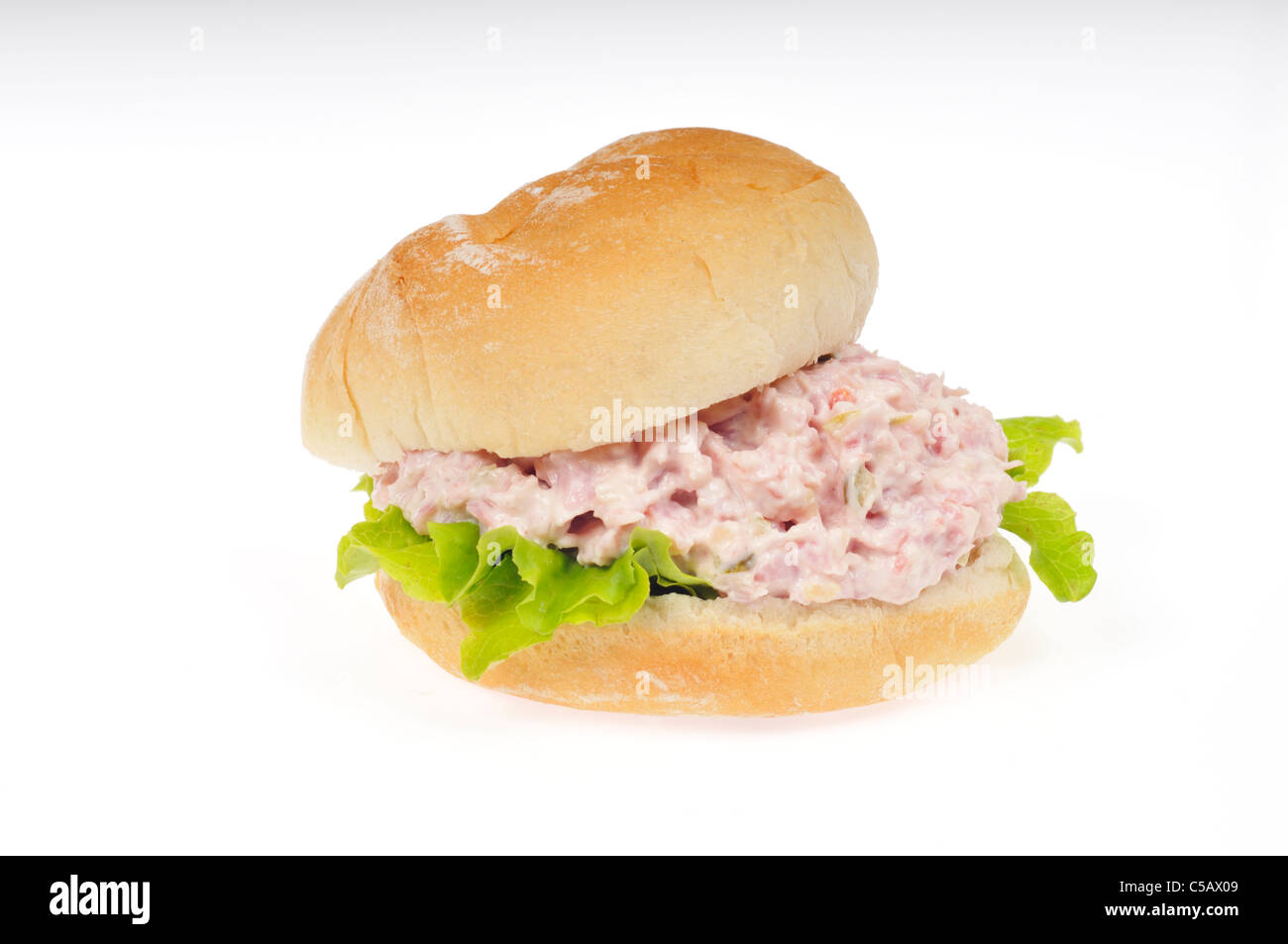 Ham salad sandwich in a roll with lettuce on white background cut out. Stock Photo