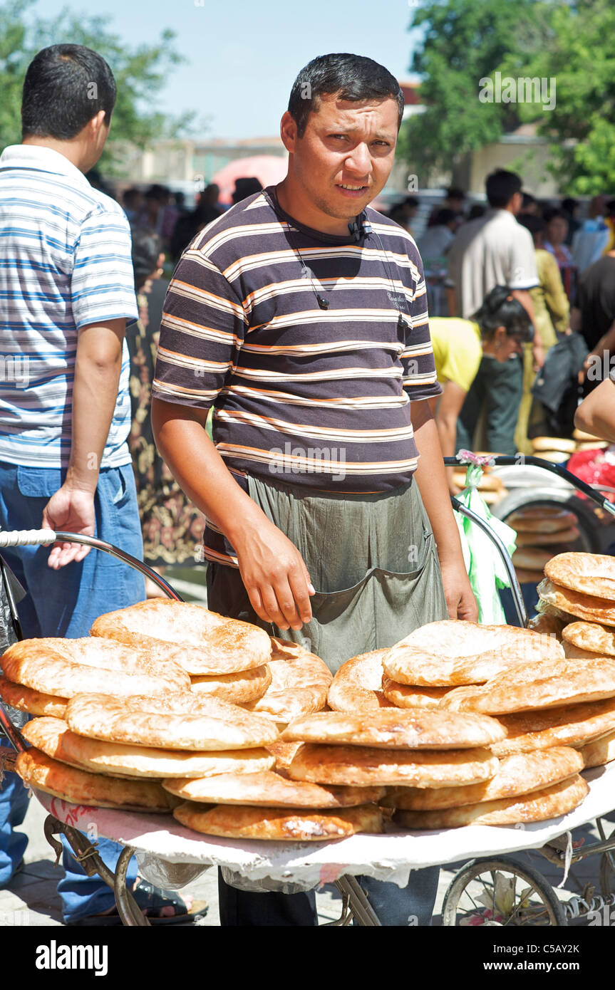 Uzbeki bread seller with Uzbeki style bread as cooked in a tandoor oven