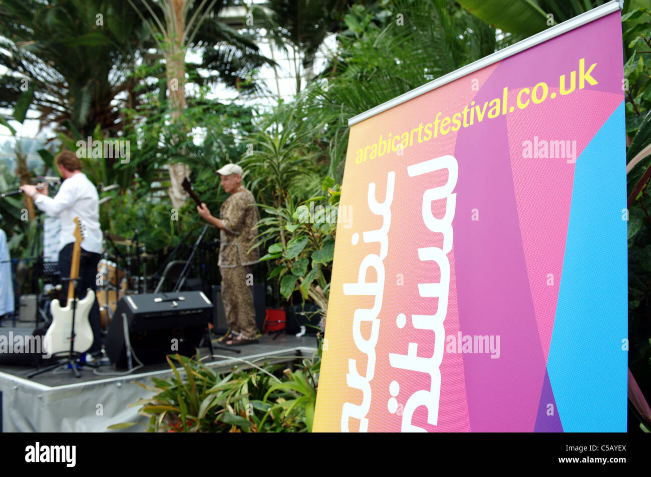 Crowd and sign ; at Liverpool Arabic Arts Festival, Palm House Sefton
