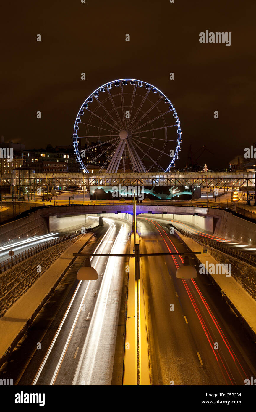 Night shot of GÃ¶tatunneln road tunnel with ferris wheel in the background at Gothenburg in Sweden Stock Photo