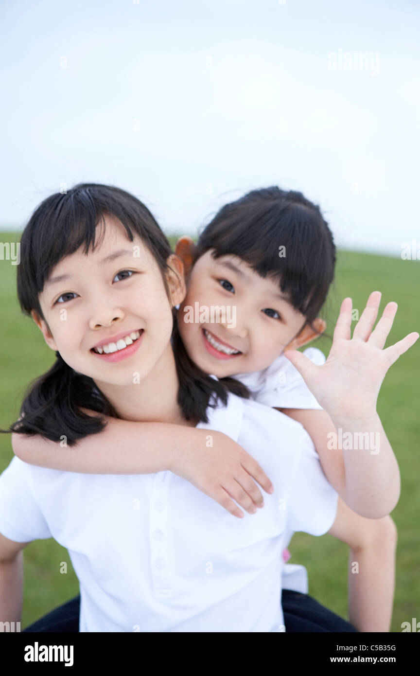Portrait of girls smiling in lawn Stock Photo - Alamy