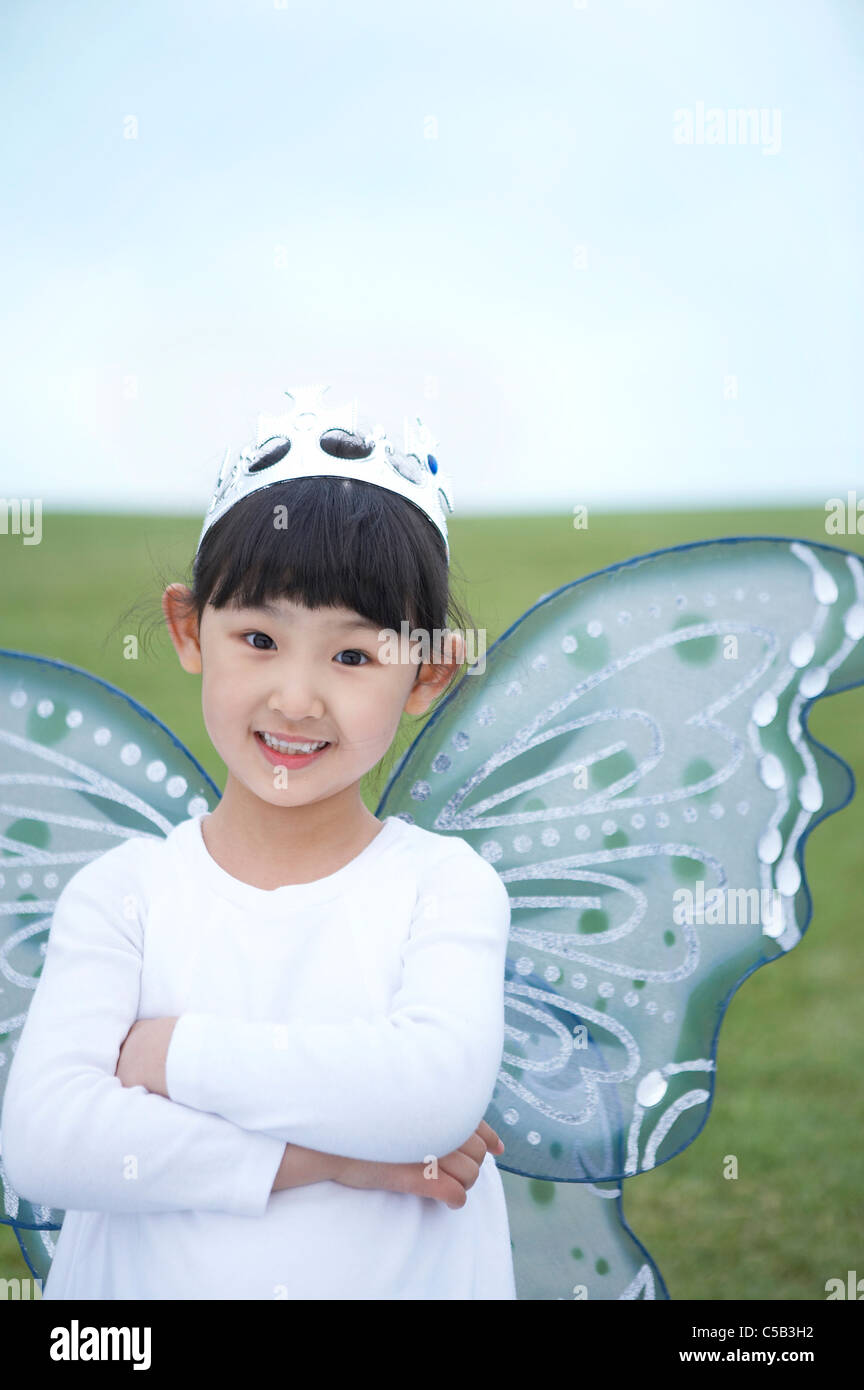 Portrait of girl wearing crown and wings Stock Photo