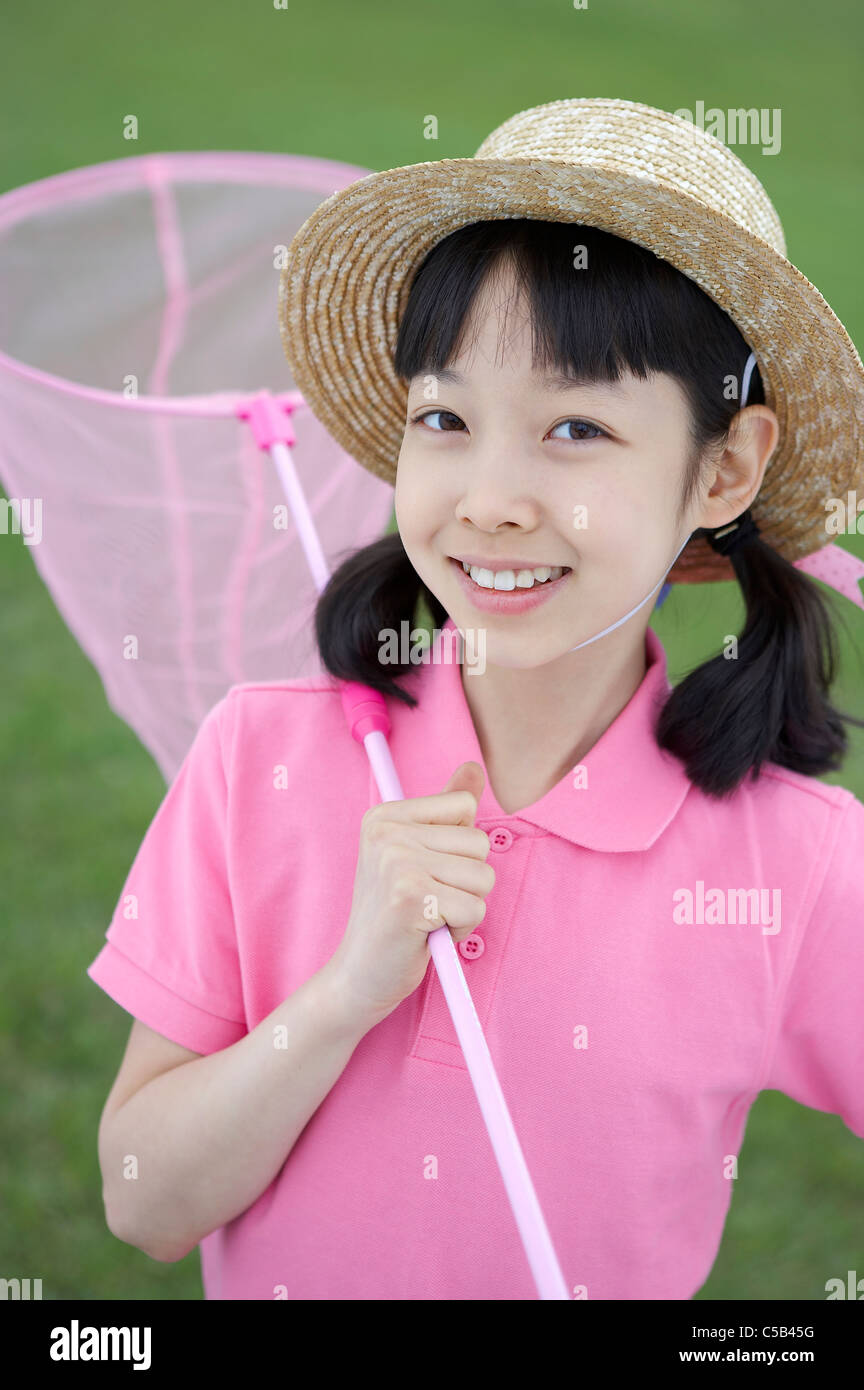 Portrait of girl holding fishing net in garden Stock Photo Alamy