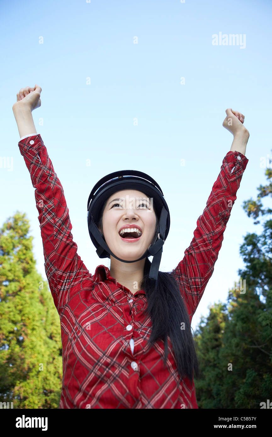 Close-up of Young woman smiling with her arms raised Stock Photo - Alamy