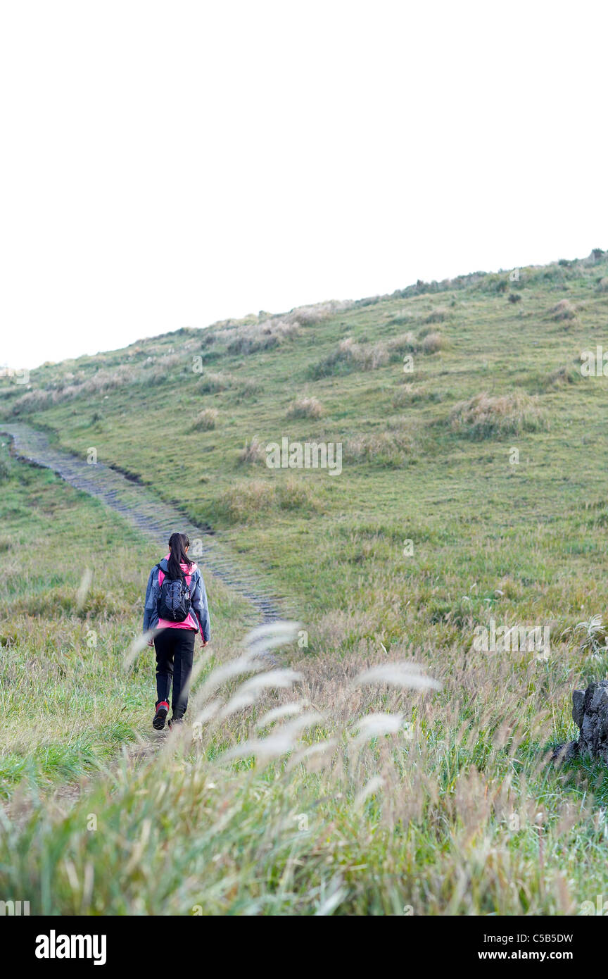Rear view of woman hiking Stock Photo - Alamy