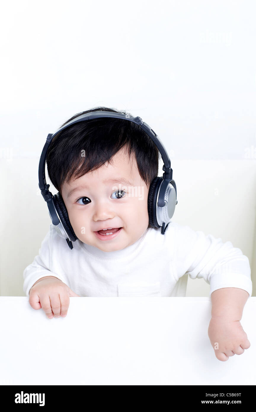 Portrait of Baby boy listening to music Stock Photo - Alamy