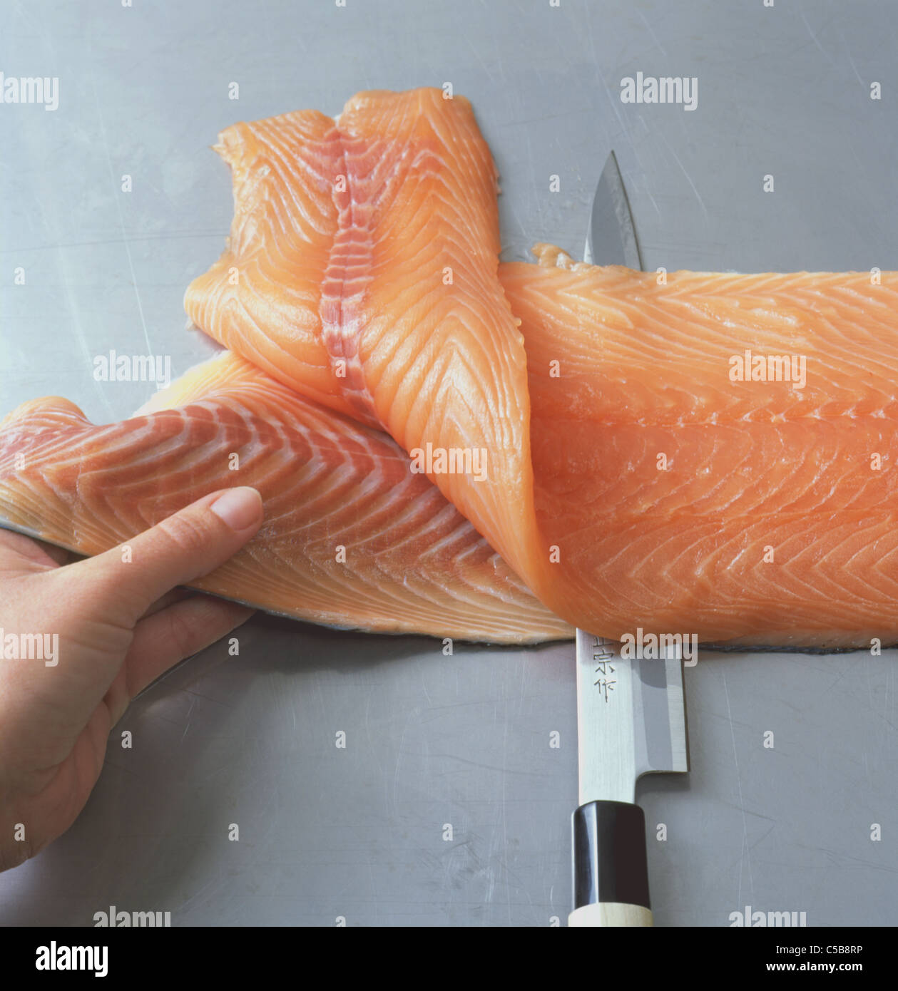 Sashimi Step Cutting salmon fillet form the skin Stock Photo Alamy