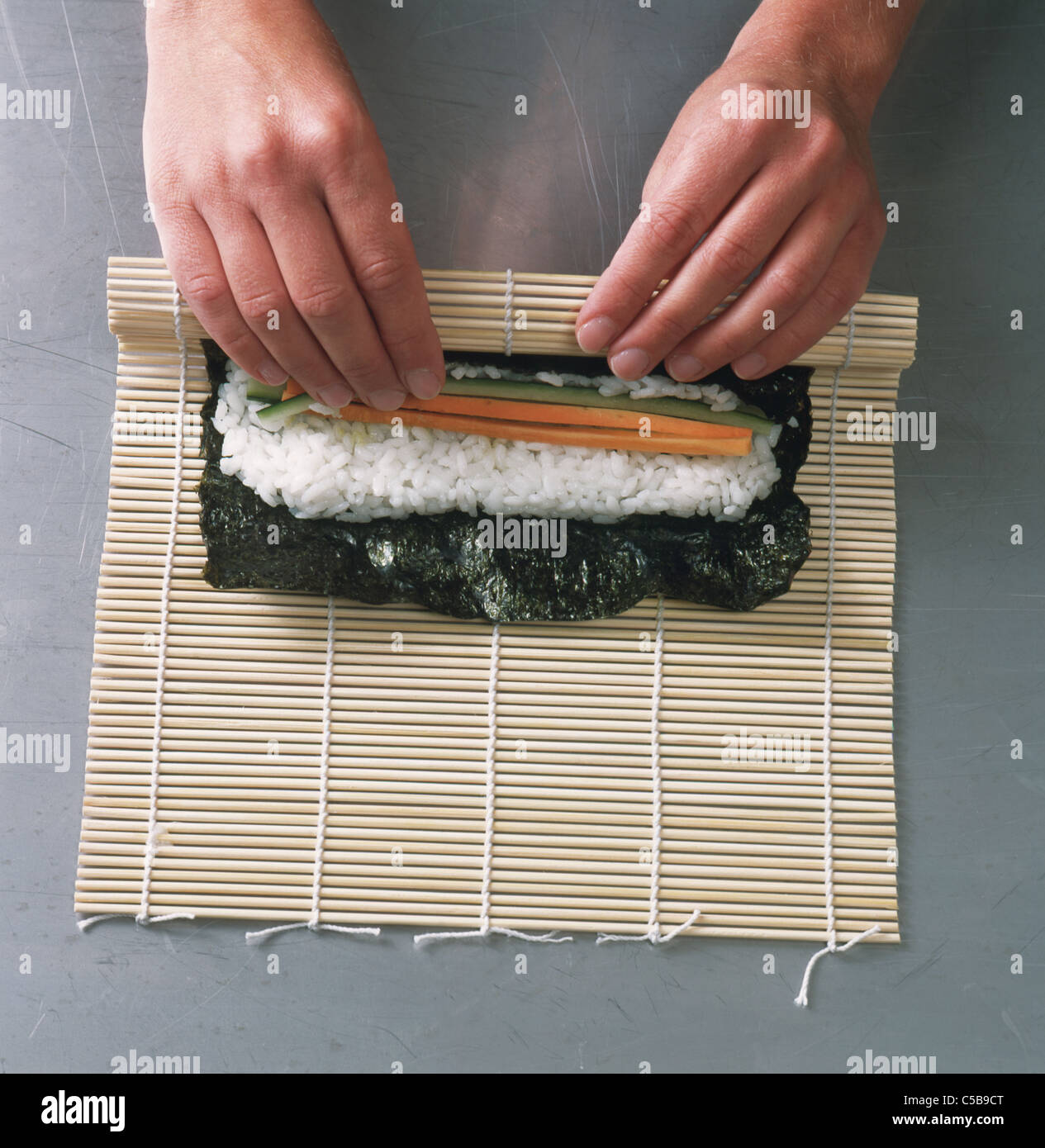 Hosomaki Step Rolling Up Bamboo Mat While Fixing The Filling