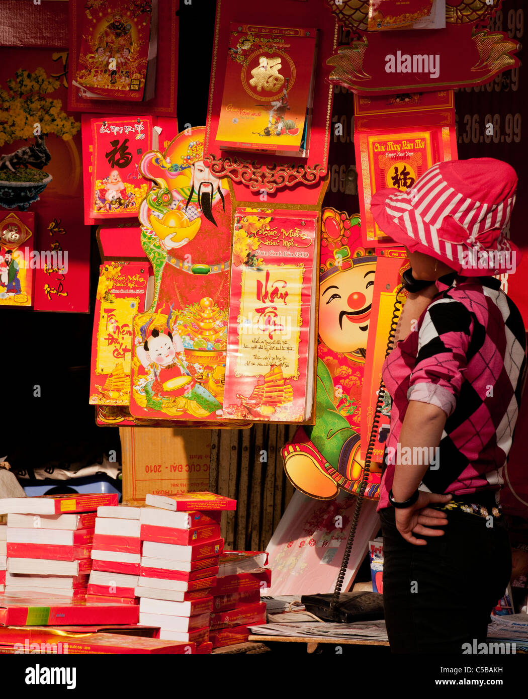 New Year Tet calendars for sale at a stall in Hang Trong St, Hanoi Old Quarter, Vietnam Stock Photo