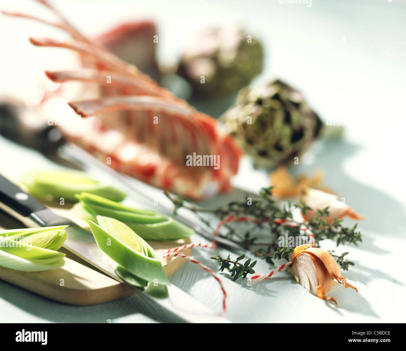 Still: raw Lamm cutlets, artichokes,onions,  leek, thyme Stock Photo