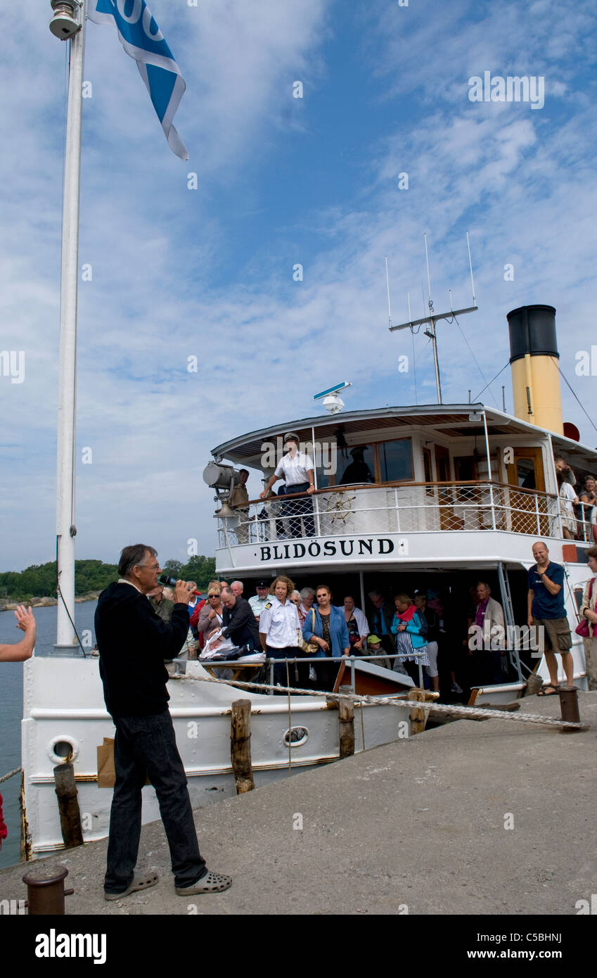 Stockholm archipelago's last coal-fired steamboat The S/S Blidösund celebrating its 100th birthday on the island of Rödlöga. Stock Photo