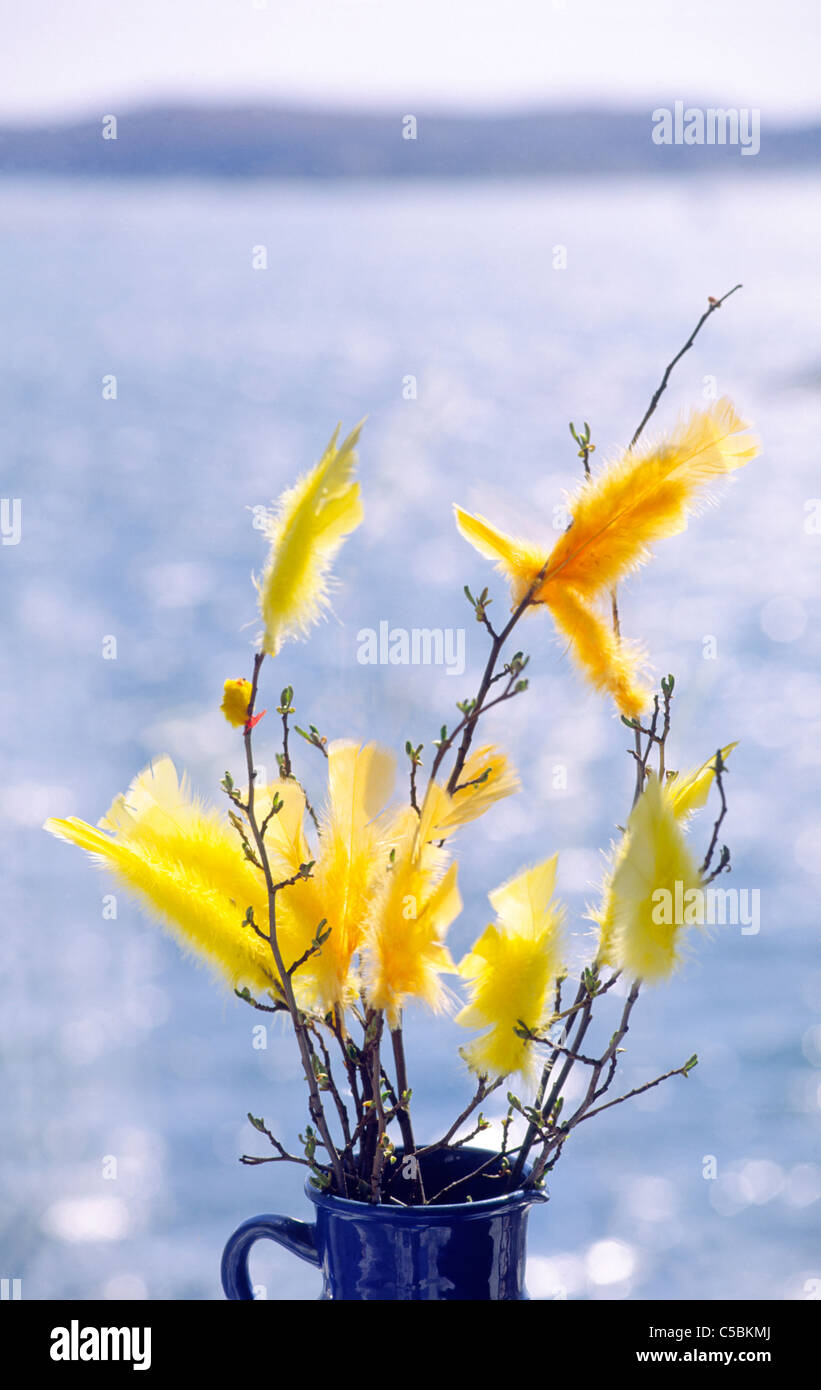 Easter Decoration With Yellow Feathers In Vase Against The Sea