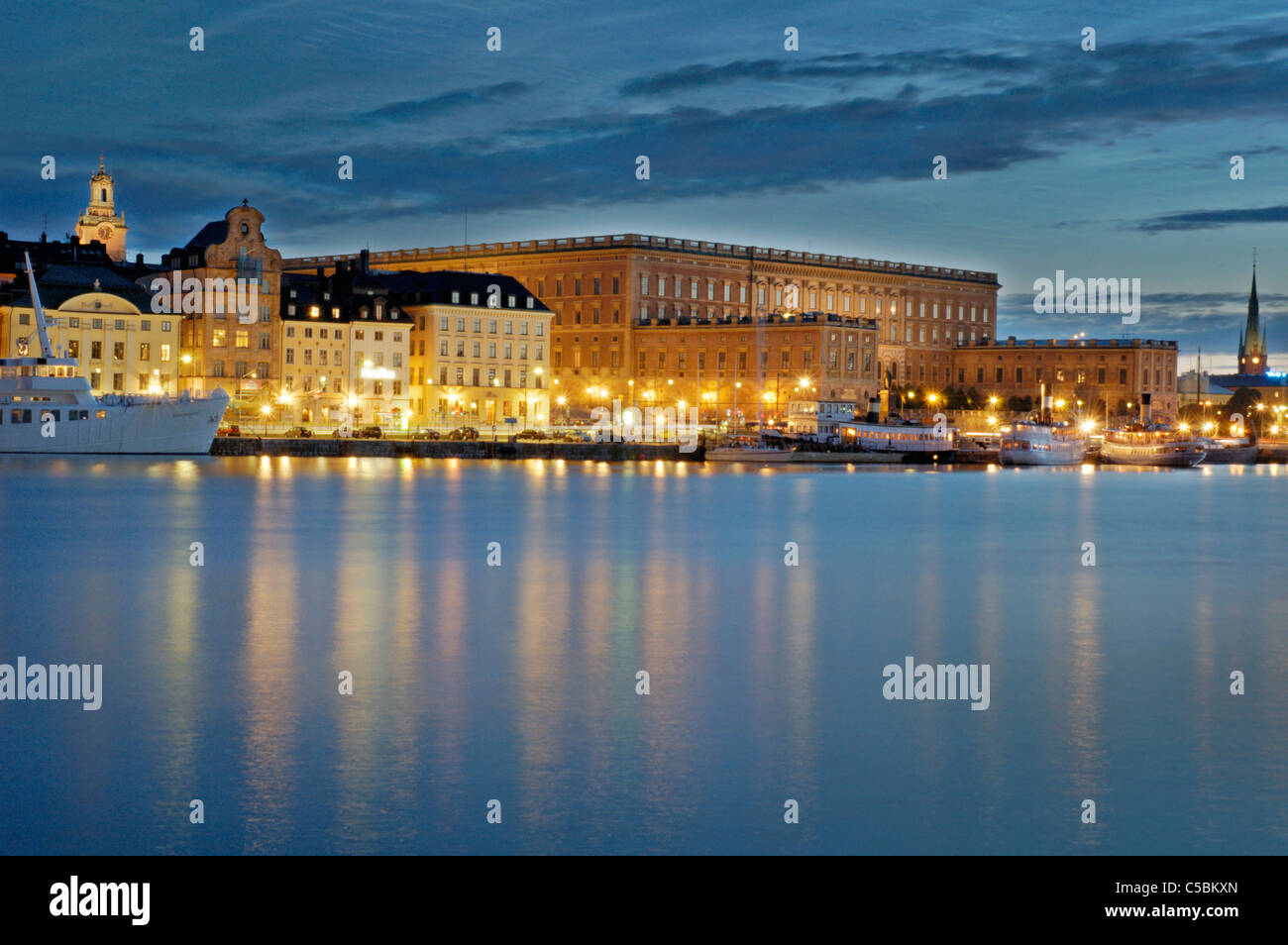 Royal castle in a distance with calm and placid sea in the foreground at night, Stockholm, Sweden Stock Photo
