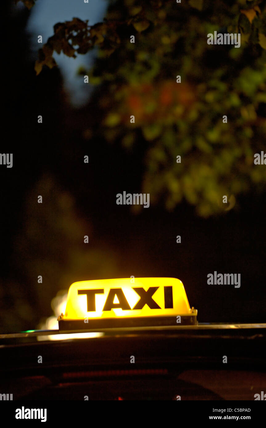 Close-up of yellow neon taxi text against blurred backgorund Stock Photo