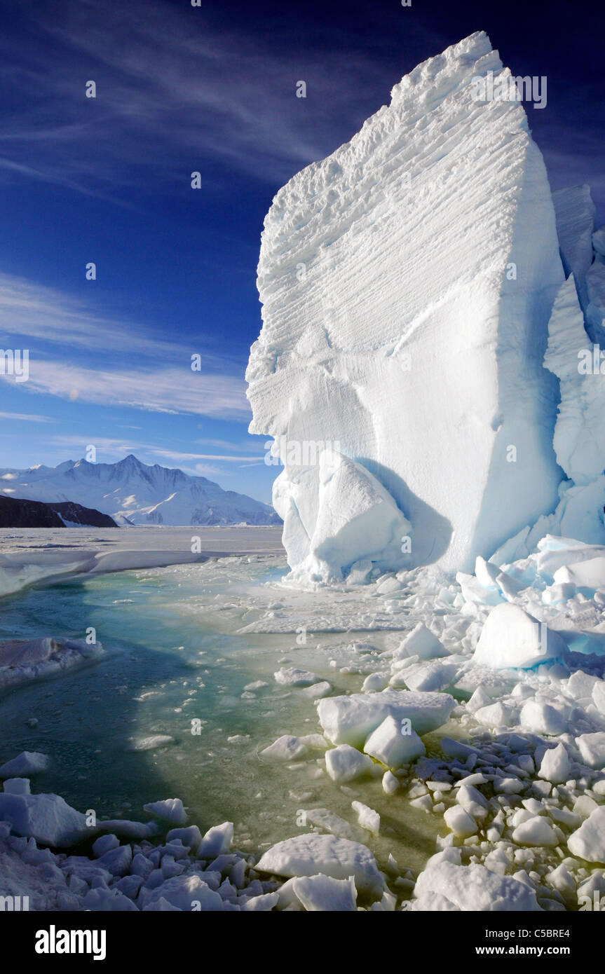 Mount Herschel with large ice berg and marine algae in pool near Cape