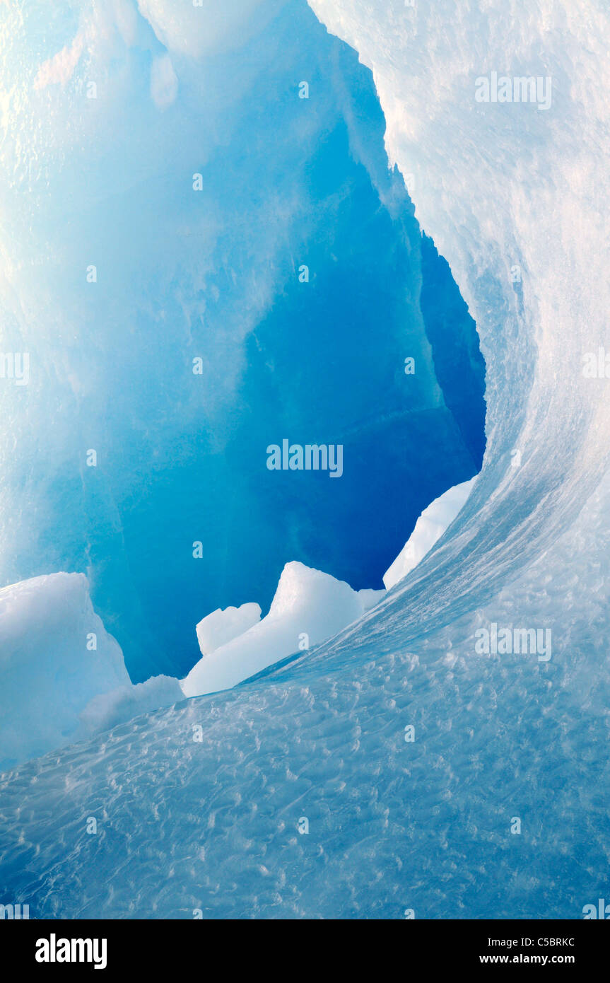 Curve in melting deep blue ice berg Antarctica Stock Photo