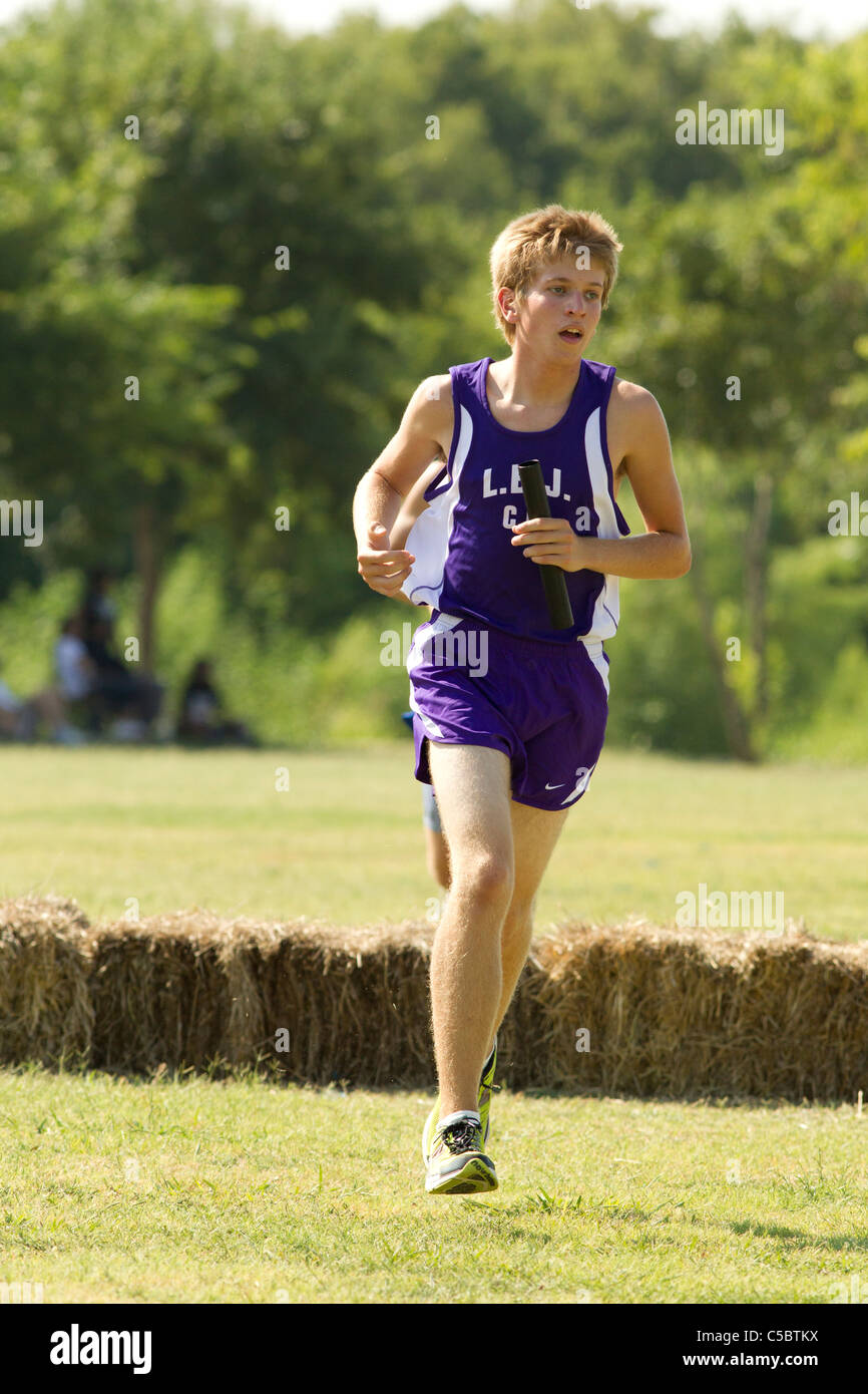 Pflugerville Texas USA, August 27, 2010: White male athlete in track uniform competes in high school cross country meet. ©Bob Daemmrich Stock Photo