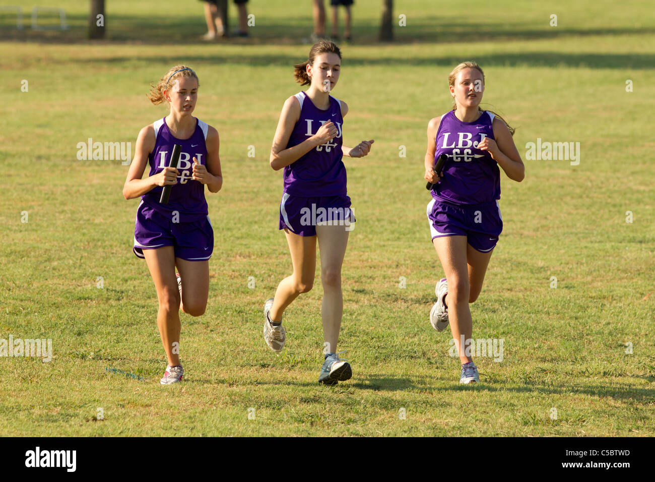 Pflugerville Texas USA, August 27, 2010: Female athletes in track uniforms compete in high school cross country meet. ©Bob Daemmrich Stock Photo