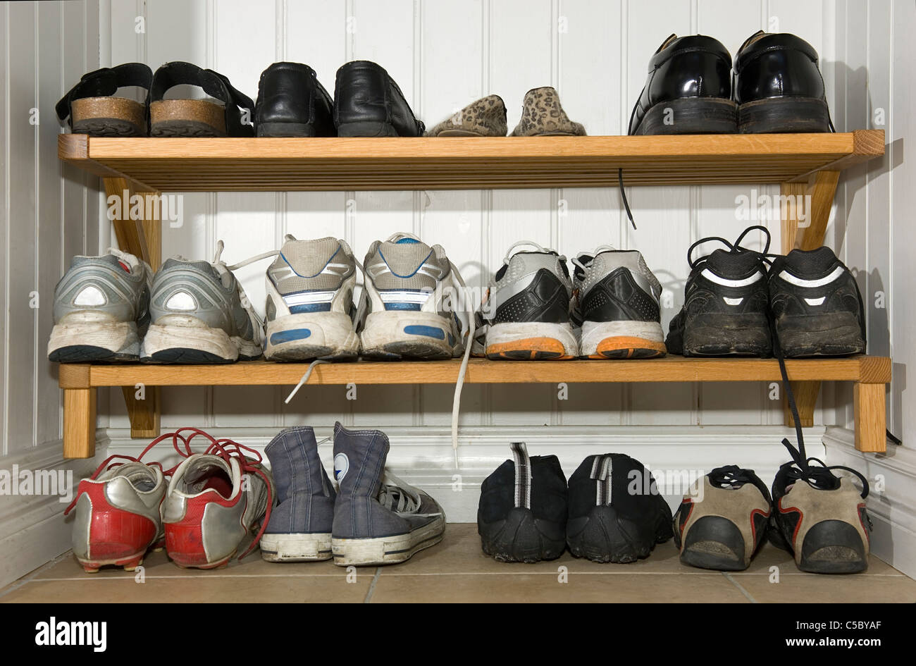 Shoes arranged in a line on the rack Stock Photo