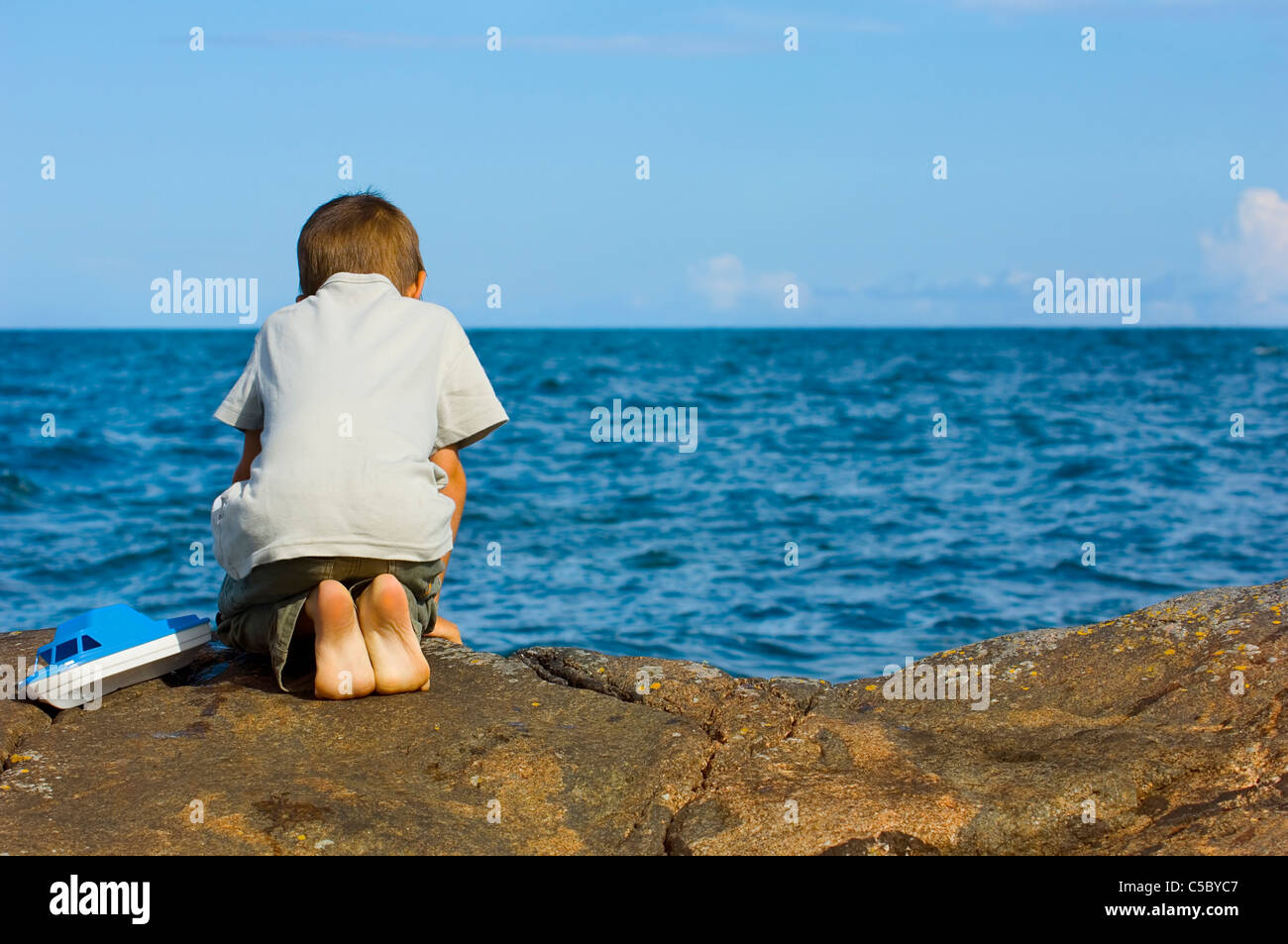 Rear view of a boy kneeling hi-res stock photography and images - Alamy
