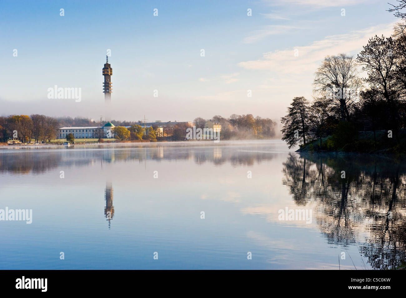KaknÃ¤stornet tower in morning fog at a distance with reflection in peaceful water Stock Photo