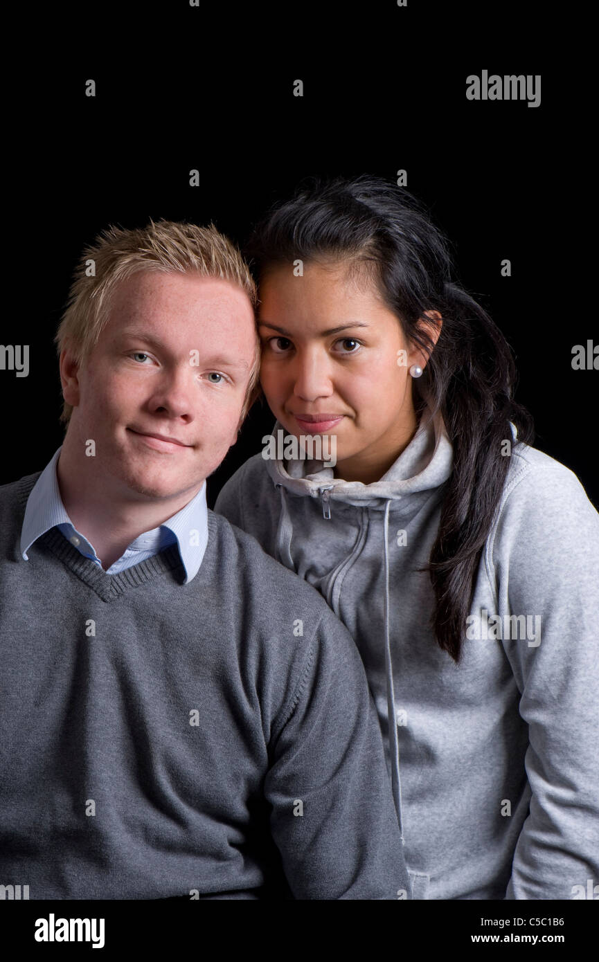 Portrait of a teenager boy and girl against black background Stock Photo