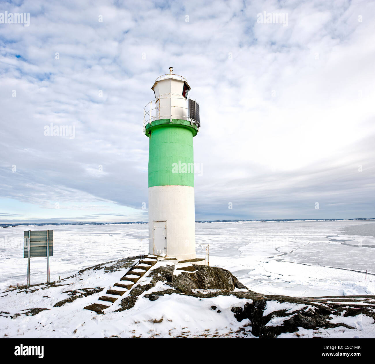 ValÃ¶ lighthouse by the sea and below cloudy sky in winter Stock Photo