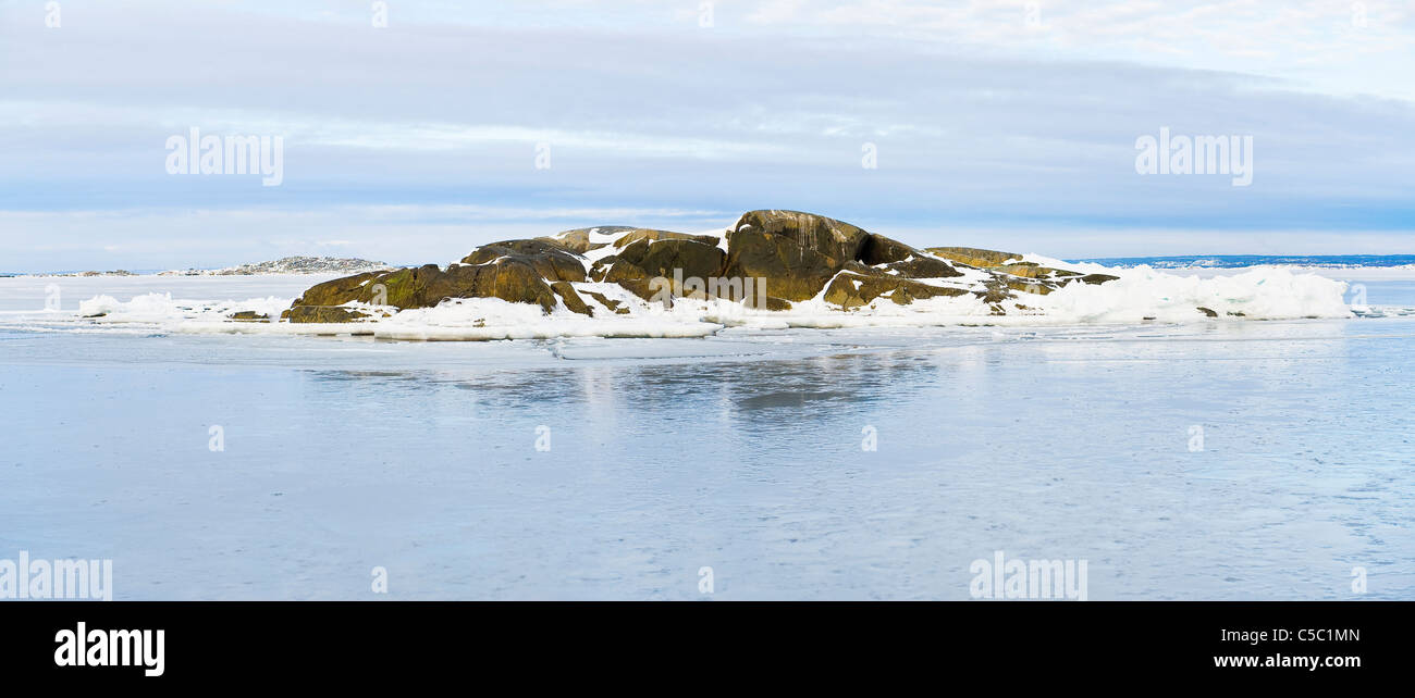 Panoramic mid distance shot of frozen in islet amid the sea at Gothenburg, Sweden Stock Photo