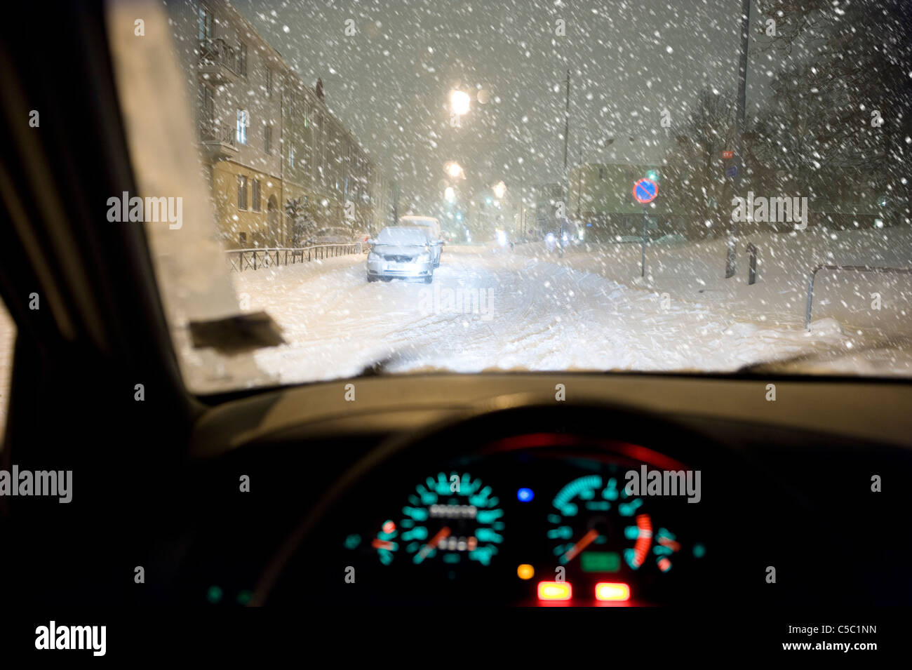 View of snowfall at city traffic from the car's windshield Stock Photo