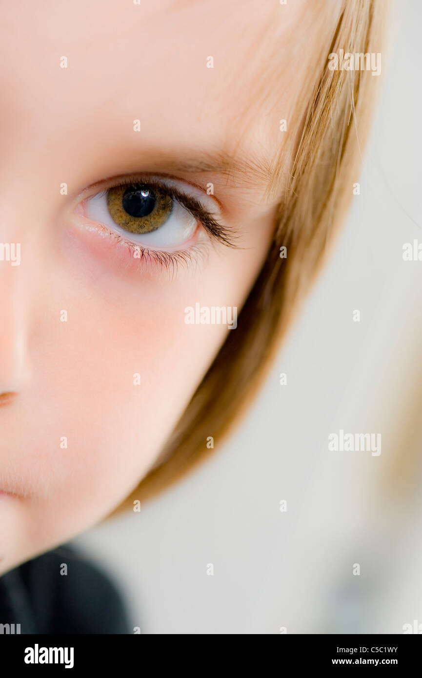 Detail portrait shot of a kid's eye against blurred background Stock Photo