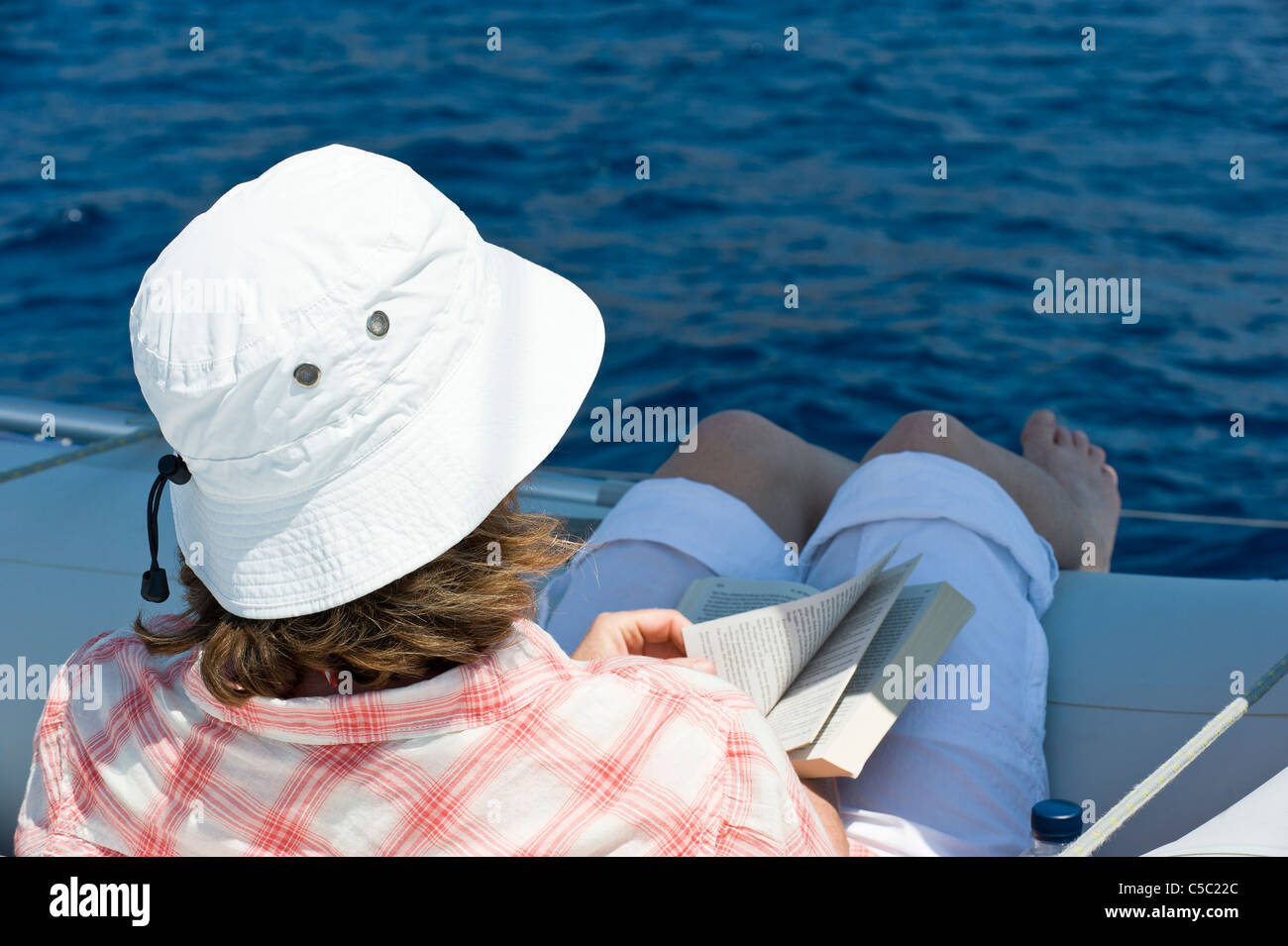 Rear view of a roman reading book on the boat Stock Photo
