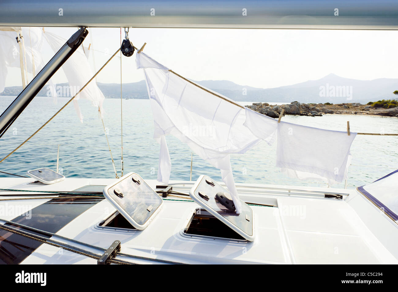 Clothing out to dry on sailboat against sunlight Stock Photo