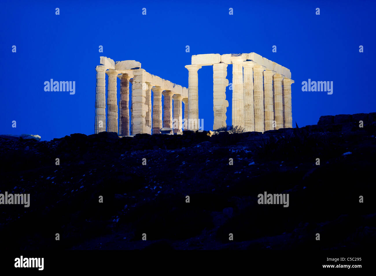 Low angle view of Cape Sounion against clear blue sky at night, Greece Stock Photo