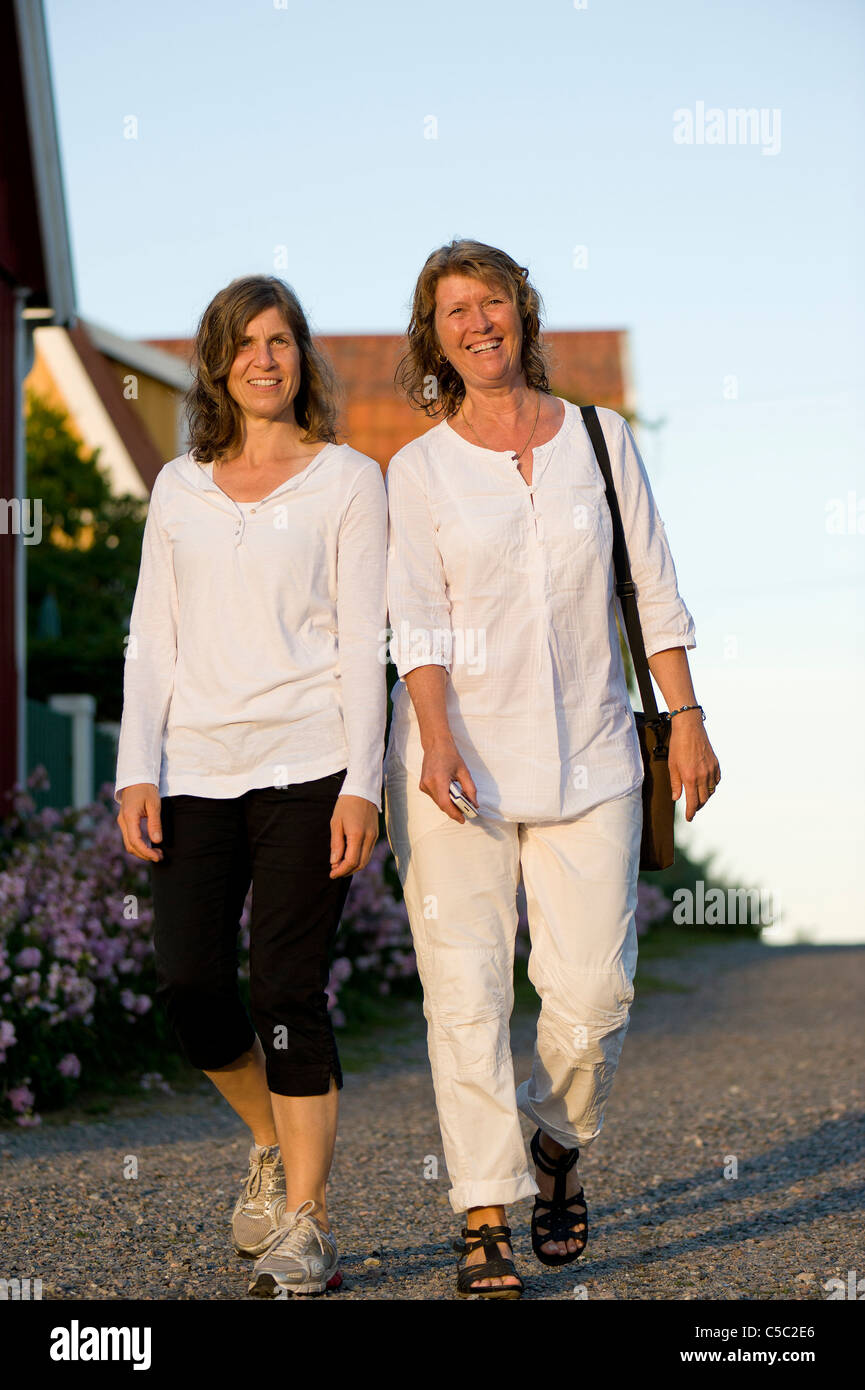 Full length portrait of two mature women walking on the street Stock Photo