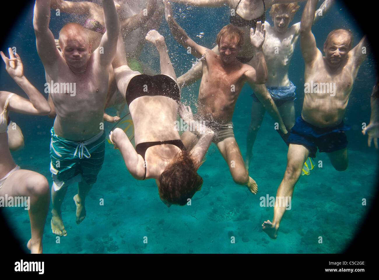Many people under the water swimming Stock Photo