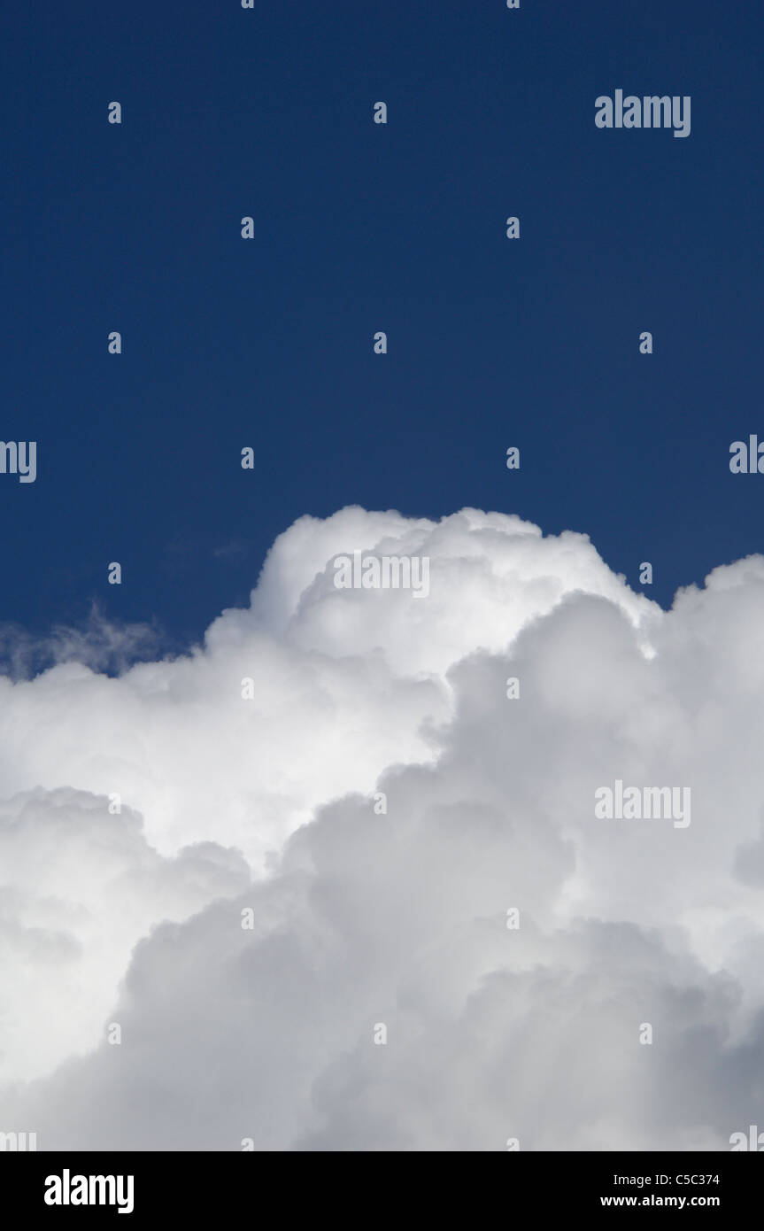 Close-up of Fleecy clouds against clear blue sky Stock Photo