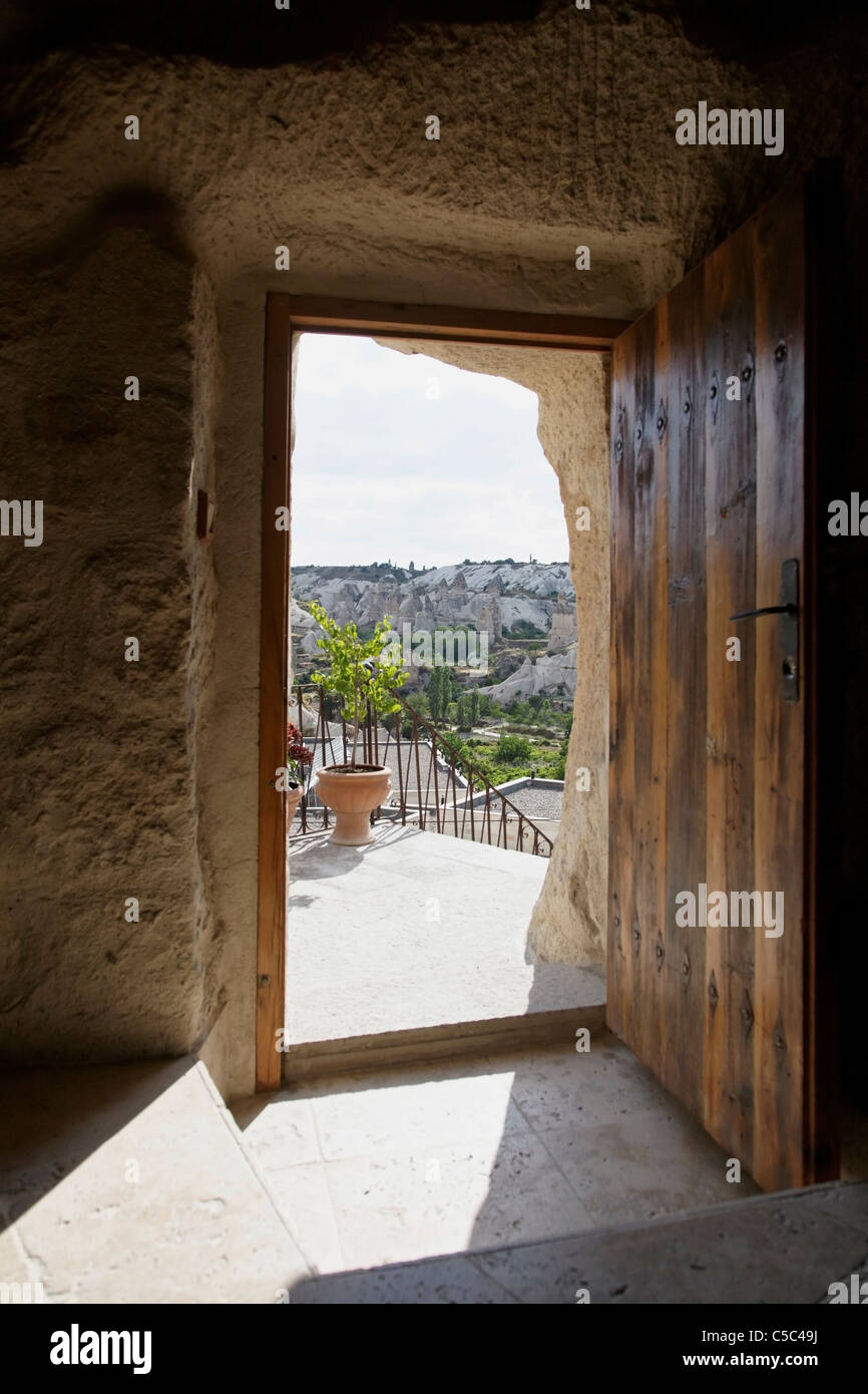 Open doorway of Koza Cave with a view of Goreme hills and natural chimney caves, Cappodocia, Turkey. Portrait copy space Stock Photo