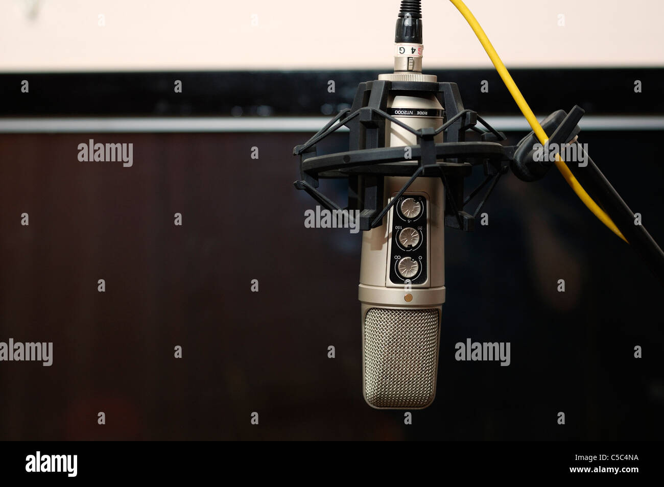 Closeup of a recording microphone in a audio post production room. Stock Photo