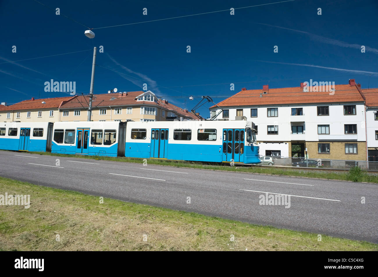 Tram with apartments against blue sky in the background at Gothenburg, Sweden Stock Photo
